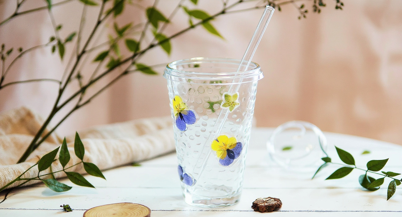 Handmade Pressed Flower Glass Cup Set on botanical book with ceramic teapot.