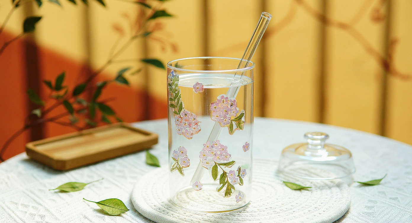 Handcrafted Preserved Flower Glass Cup with gift wrapping and baby's breath on linen tablecloth.