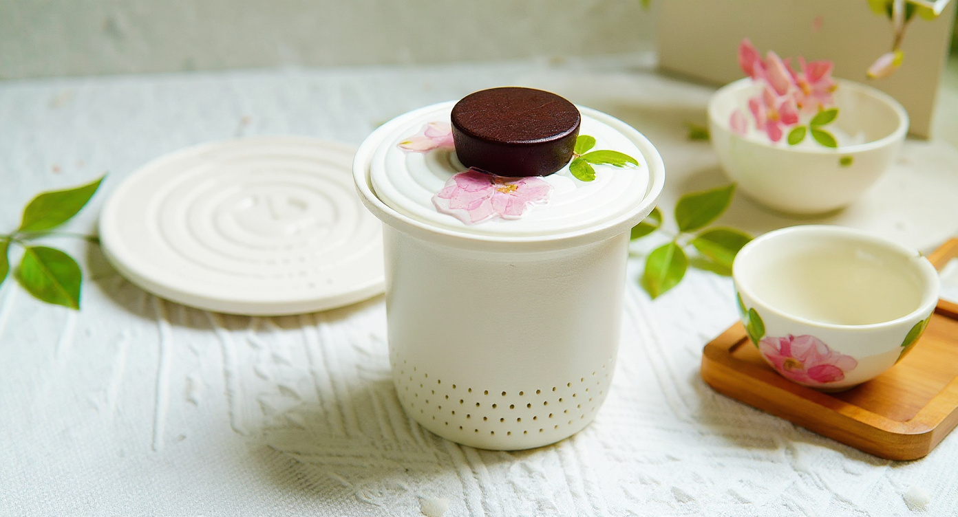 Handmade Frosted Porcelain Tea Set with real preserved flowers displayed among dried botanicals.
