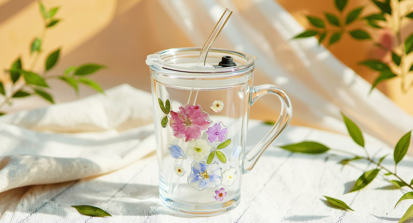 Pressed Flower Glass Tumbler with lemonade, ice, and wildflower stems on linen.