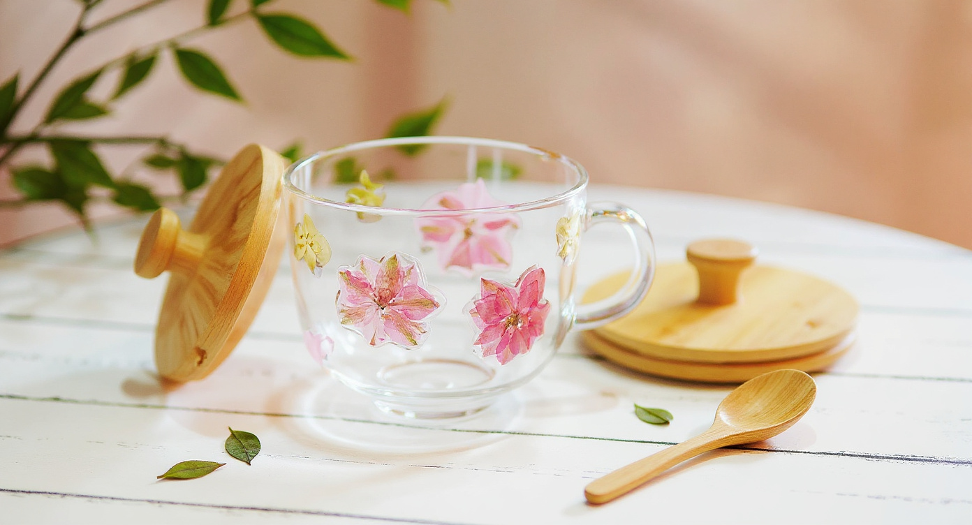 Handmade Real Flower Resin Glass Mug on wood tray with eucalyptus, book and brass spoon