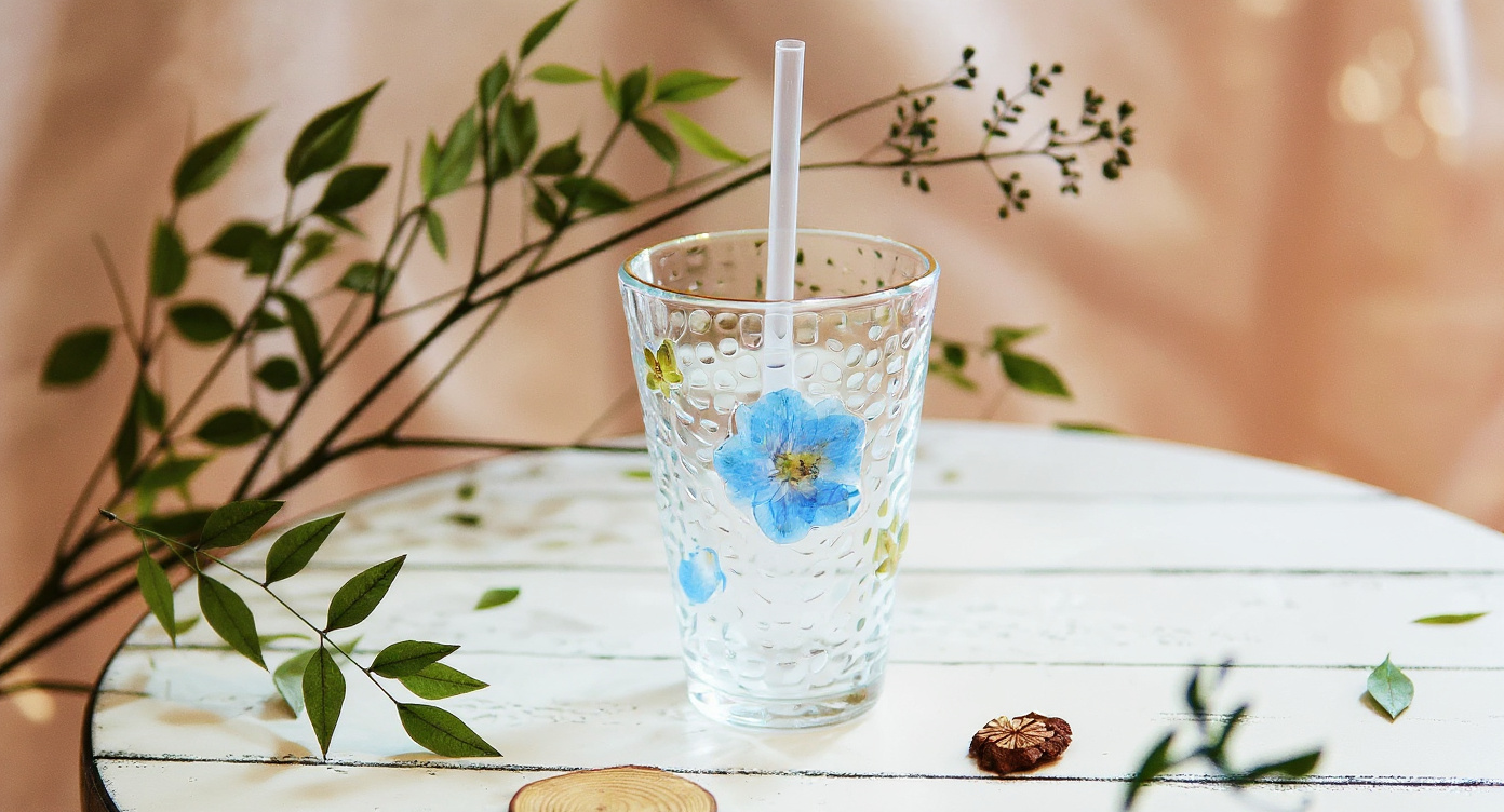Handmade Pressed Flower Glass Cup Set 400ml with real floral drinkware on sage linen beside ceramic teapot.
