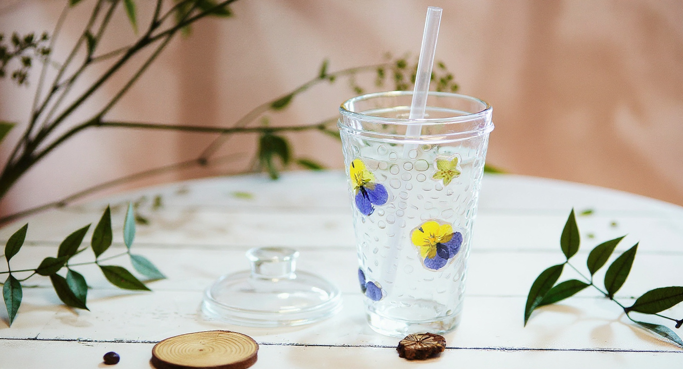 Handmade Pressed Flower Glass Cup Set 400ml on marble with open botanical book and petals.